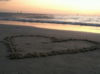Beach sunset with heart in the sand